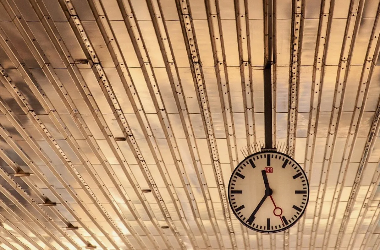 Station clock hanging from a slatted ceiling