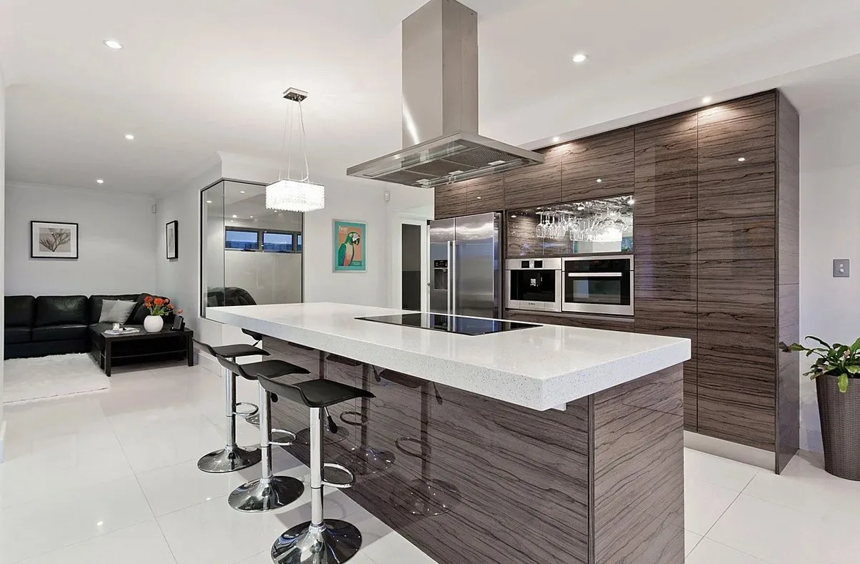 Modern kitchen with an island, bar stools and a steel extractor hood